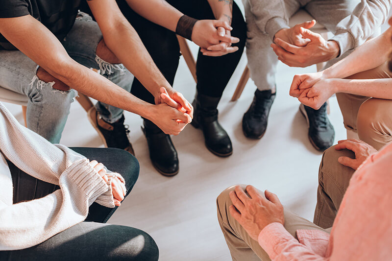 People participate in group therapy in a mental health treatment program.