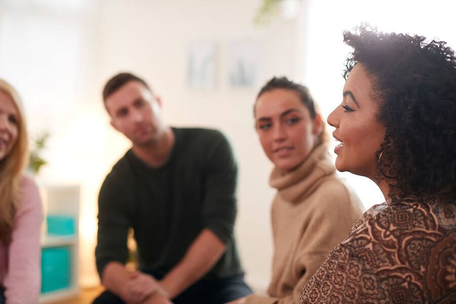 People participate in group therapy at a drug rehab center.