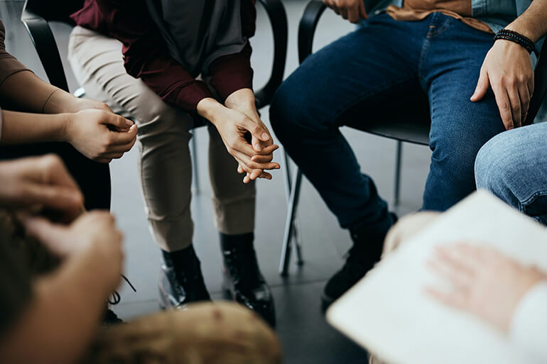 People participate in group therapy at a mental health treatment center.